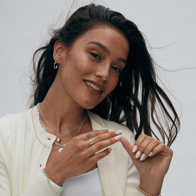 A woman proudly wearing the Harvard H Ruby Ring Limited Edition, showcasing its elegance and symbolic Harvard 'H' design.