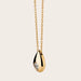 A detailed side view of the Dew Drop Diamond Solitaire Necklace of 18kt Gold. The image highlights the fine craftsmanship and design of the necklace. The solitaire diamond, set in a prong setting, hangs delicately from the curb link chain. The 18kt gold chain gleams from the side, showcasing its quality and shine.