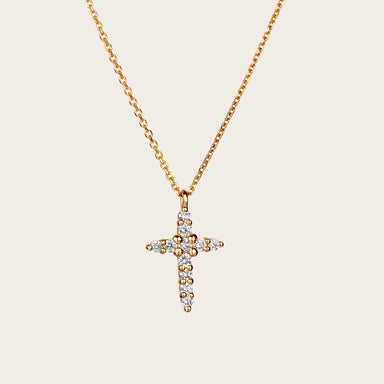 Close-up view of a sparkling cross diamond pendant with 11 brilliant-cut diamonds set in a sturdy 14kt yellow gold setting. The diamonds beautifully adorn the cross, creating a dazzling display of light and adding a touch of elegance to any outfit.
