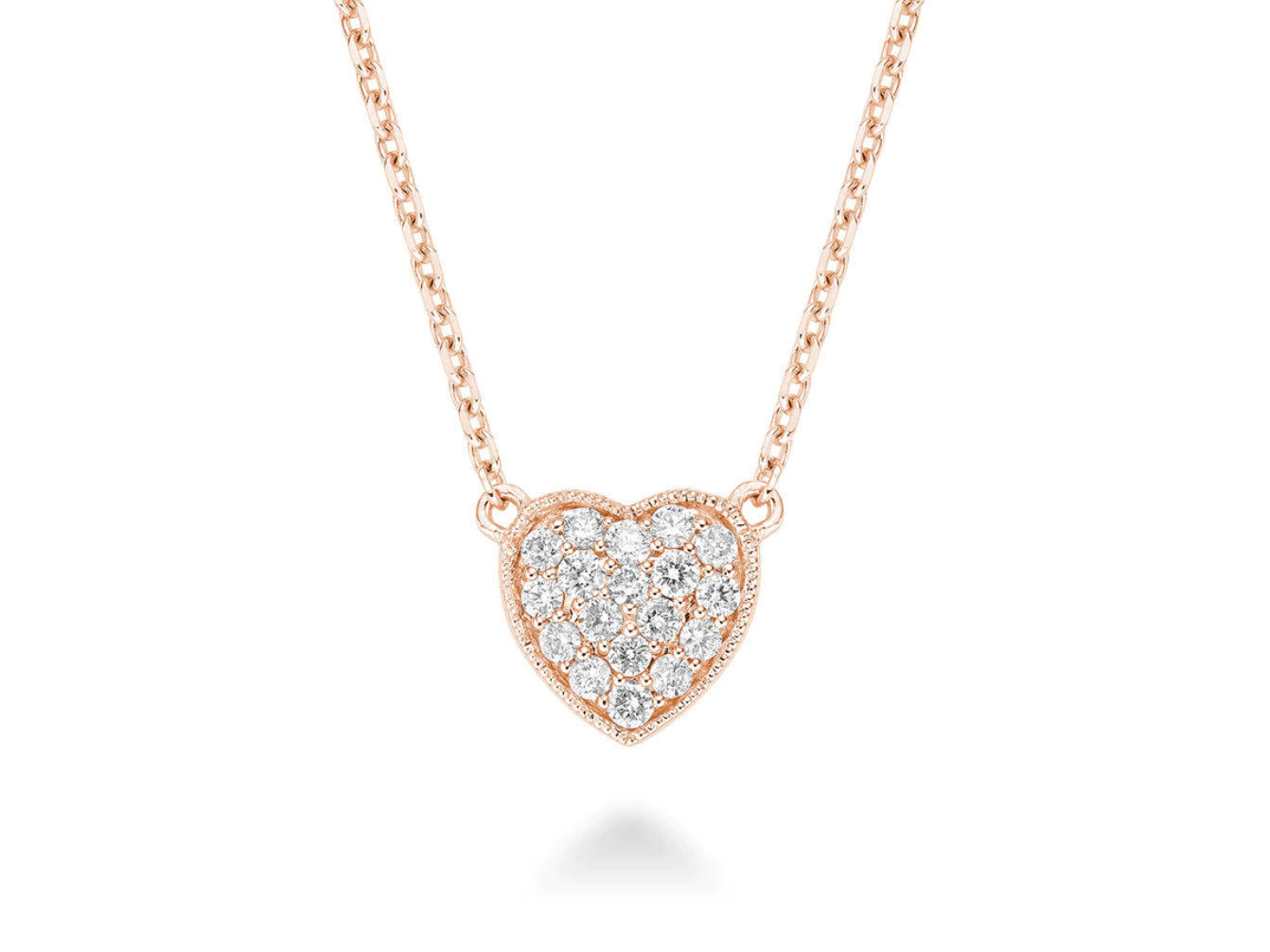A close-up of a diamond heart necklace made of 14kt rose gold. The necklace features a heart-shaped pendant set with sparkling diamonds. The rose gold of the necklace is warm and feminine, making it a perfect choice for a woman who wants to add a touch of glamour to her look.