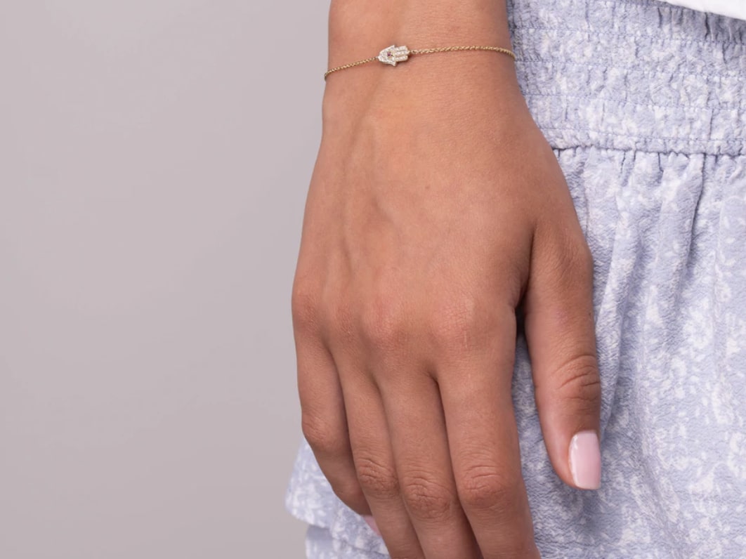A close-up image of a Hamsa Bracelet on a hand.