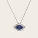 This image shows a close-up view of an Evil Eye Blue Sapphire and Diamond Pendant. The pendant is made of 18kt white gold and features a blue sapphire in the center surrounded by diamonds. The pendant is beautifully crafted and would make a stunning addition to any jewelry collection.