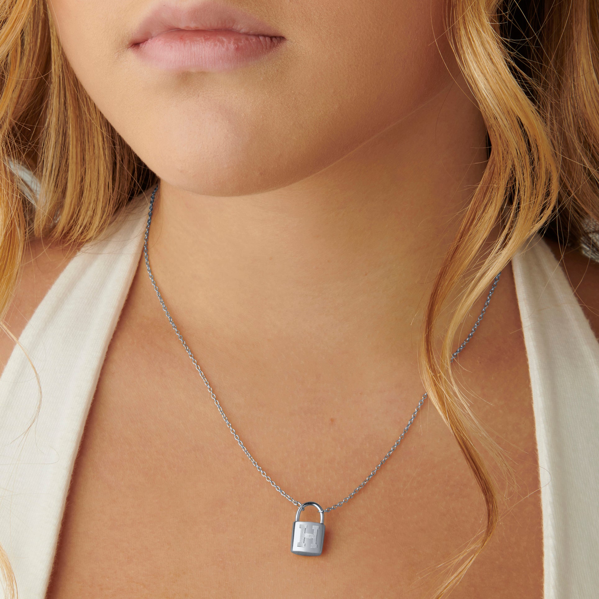 Close-up view of a woman wearing the sterling silver Harvard Padlock Pendant, an elegant accessory for Harvard enthusiasts