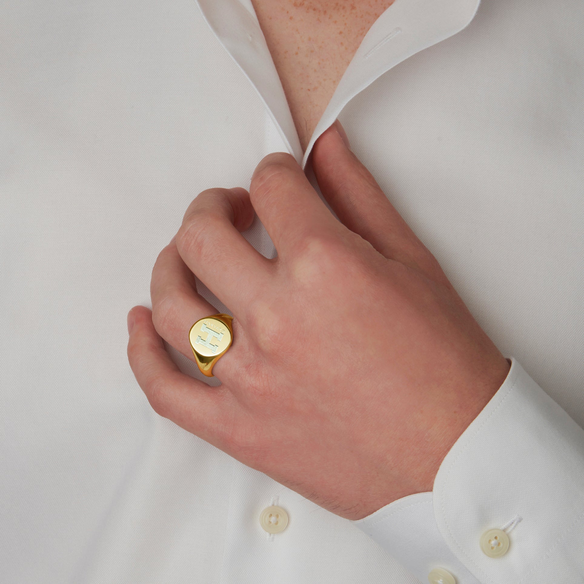 A man showcasing the Harvard Meta Ring in gold vermeil silver, a symbol of his success and affiliation with Harvard University - Harvard class ring