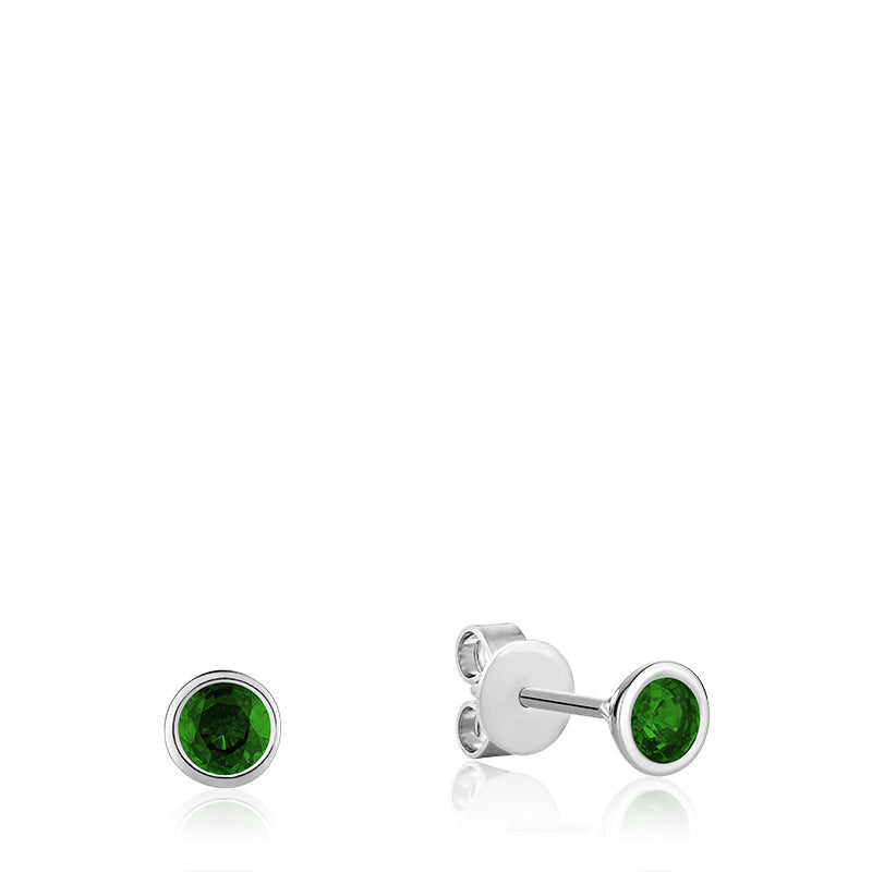 A pair of emerald earrings made of 10kt white gold. The earrings feature a bezel mount that protects the emeralds and highlights their beauty. The earrings are versatile and can be worn with a variety of different looks.