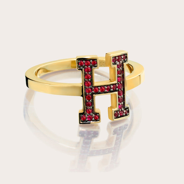 Harvard H Ruby Ring Limited Edition: A close-up view of the ring featuring the Harvard 'H' symbol surrounded by crimson red rubies on a white background.